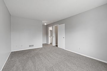 Eagan townhouse for rent - a spacious living room with carpet and white walls