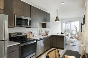 St. Paul apartment for rent - A modern kitchen with dark brown cabinets and stainless steel appliances.