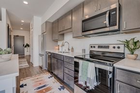 St. Paul apartment for rent - A modern kitchen with a stove top oven and microwave above it.