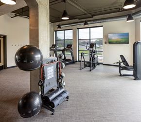 North St. Paul apartment for rent - A gym with a variety of equipment including a treadmill, a stationary bike, and a weight bench.