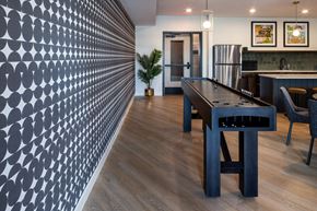 North St. Paul apartment for rent - A modern kitchen with a long table and chairs.