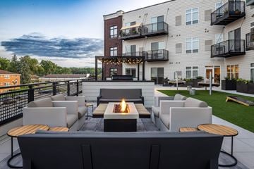 North St. Paul apartment for rent - A modern outdoor seating area with a fire pit in the center.