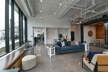 Minneapolis apartment for rent - A modern living room with a blue couch and a white coffee table.