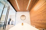 Minneapolis apartment for rent - A bedroom with a bed in the foreground and a wooden wall in the background.