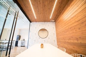 Minneapolis apartment for rent - A bedroom with a bed in the foreground and a wooden wall in the background.