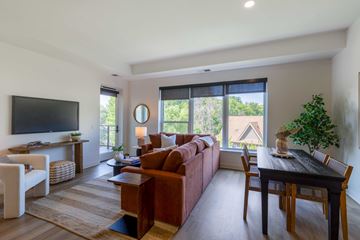 Wayzata apartment for rent - A living room with a brown couch and a television.