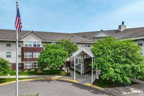 Mounds View apartment for rent - A building with a flag on top of a pole.