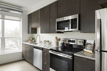 St. Paul apartment for rent - A modern kitchen with a stainless steel refrigerator, oven, and microwave.