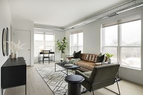 St. Paul apartment for rent - a living room with a brown leather couch and a black coffee table