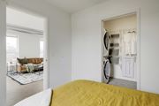 St. Paul apartment for rent - a bedroom with a bed and a closet with a washer and dryer
