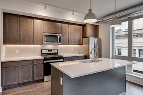 St. Paul apartment for rent - a kitchen with wooden cabinets and a white counter top