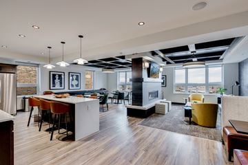 St. Paul apartment for rent - a living room and dining room with a fireplace and a table with chairs