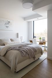 Minneapolis apartment for rent - a bedroom with a bed and a desk with a laptop