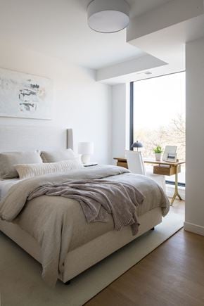 Minneapolis apartment for rent - a bedroom with a bed and a desk with a laptop