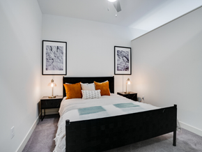 Minneapolis apartment for rent - a bedroom with a bed and two nightstands with orange pillows