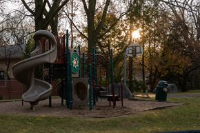 Eagan townhouse for rent - A playground with a slide, swings, and a basketball hoop.
