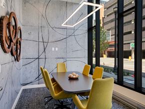Minneapolis apartment for rent - a dining room with yellow chairs and a table and large windows