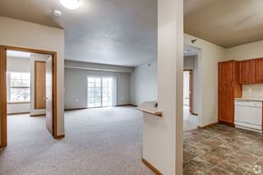 Saint Paul apartment for rent - A large, empty room with a kitchen area to the right.
