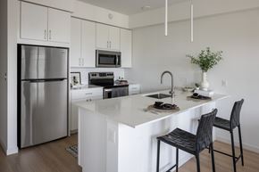 Minneapolis apartment for rent - A kitchen with a white counter and a black chair.