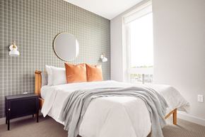 Minneapolis apartment for rent - a bedroom with a bed and a mirror