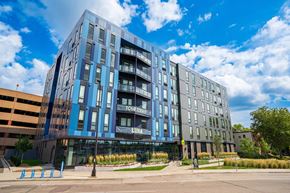 Minneapolis apartment for rent - a large blue building with a street in front of it