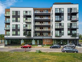 Minneapolis apartment for rent - a large apartment building with cars parked in front of it