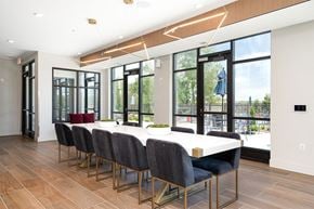 Roseville apartment for rent - a dining room with a table and chairs and windows