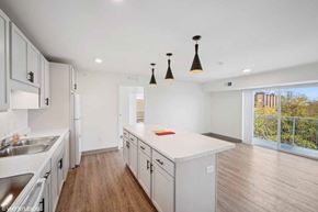Minneapolis apartment for rent - A kitchen with white cabinets and a wooden floor.