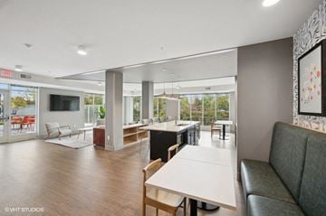 Minneapolis apartment for rent - A modern living room with a grey sofa and a dining table.