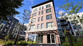 St. Paul apartment for rent - a tall building with a balcony and trees in front of it