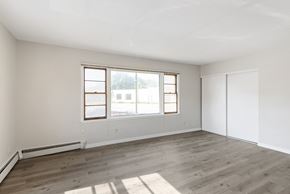 Richfield apartment for rent - A room with a window and a wooden floor.