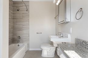 Richfield apartment for rent - A white toilet sits next to a sink in a bathroom.