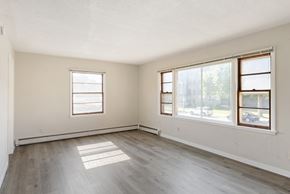 Richfield apartment for rent - A room with two windows and wooden flooring.