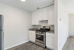 Richfield apartment for rent - A kitchen with white cabinets and stainless steel appliances.