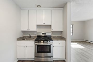 Richfield apartment for rent - A kitchen with white cabinets and a granite countertop.