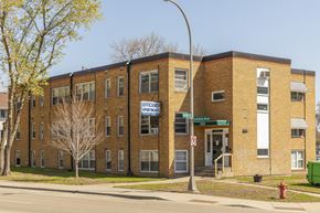 Richfield apartment for rent - A multi-story brick building with a sign that says "Efficiency Apartments.".