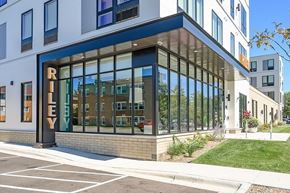 Richfield apartment for rent - A modern building with a glass facade and a sign that reads "RILEY".