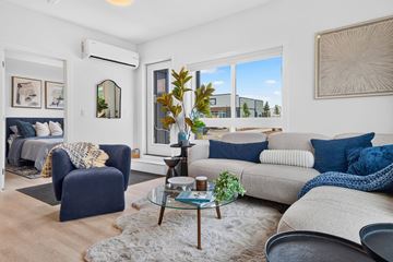 Edmonton apartment for rent - A living room with a blue chair and a grey couch.