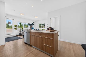 Edmonton apartment for rent - A kitchen with a white counter top and wooden cabinets.