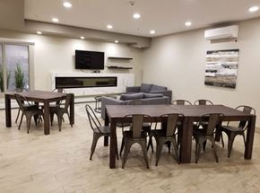 Edmonton apartment for rent - A modern dining room with a large table and chairs.