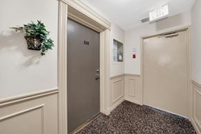 Aurora apartment for rent - a hallway with two doors and a plant on the wall