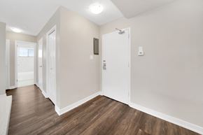 Aurora apartment for rent - a bedroom with hardwood flooring and white walls