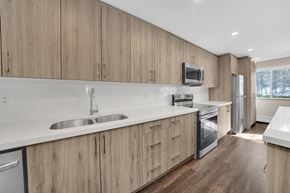 Aurora apartment for rent - a kitchen with white countertops and wooden cabinets