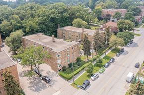 Toronto apartment for rent - an aerial view of a brick building with cars parked on the side of the road