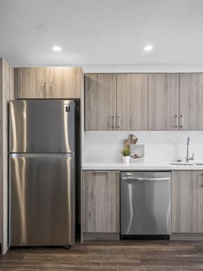 Toronto apartment for rent - a kitchen with wooden cabinets and a stainless steel refrigerator