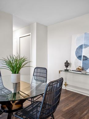 Toronto apartment for rent - a dining room with a glass table and four chairs