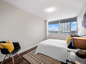 Toronto apartment for rent - a bedroom with a bed and a chair in front of a window