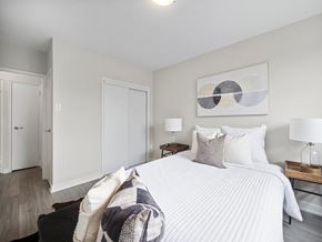 Toronto apartment for rent - A bedroom with a large bed and a painting on the wall.