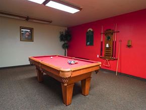 Taylor apartment for rent - A pool table in a room with red walls.