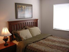 Taylor apartment for rent - A bedroom with a bed, lamp, and picture on the wall.
